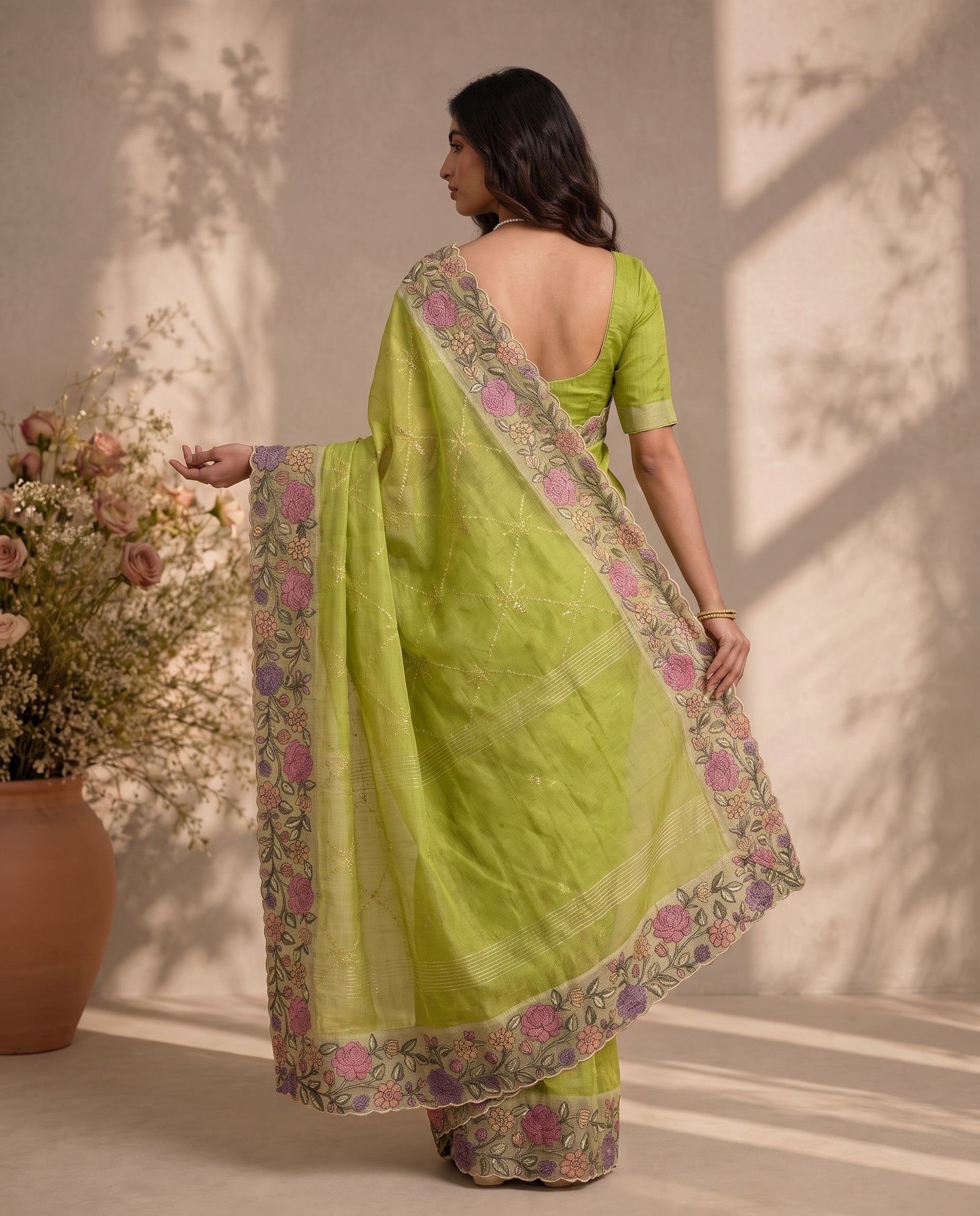 Back view of draped pure kota silk saree in green showing fabric texture and pallu fall