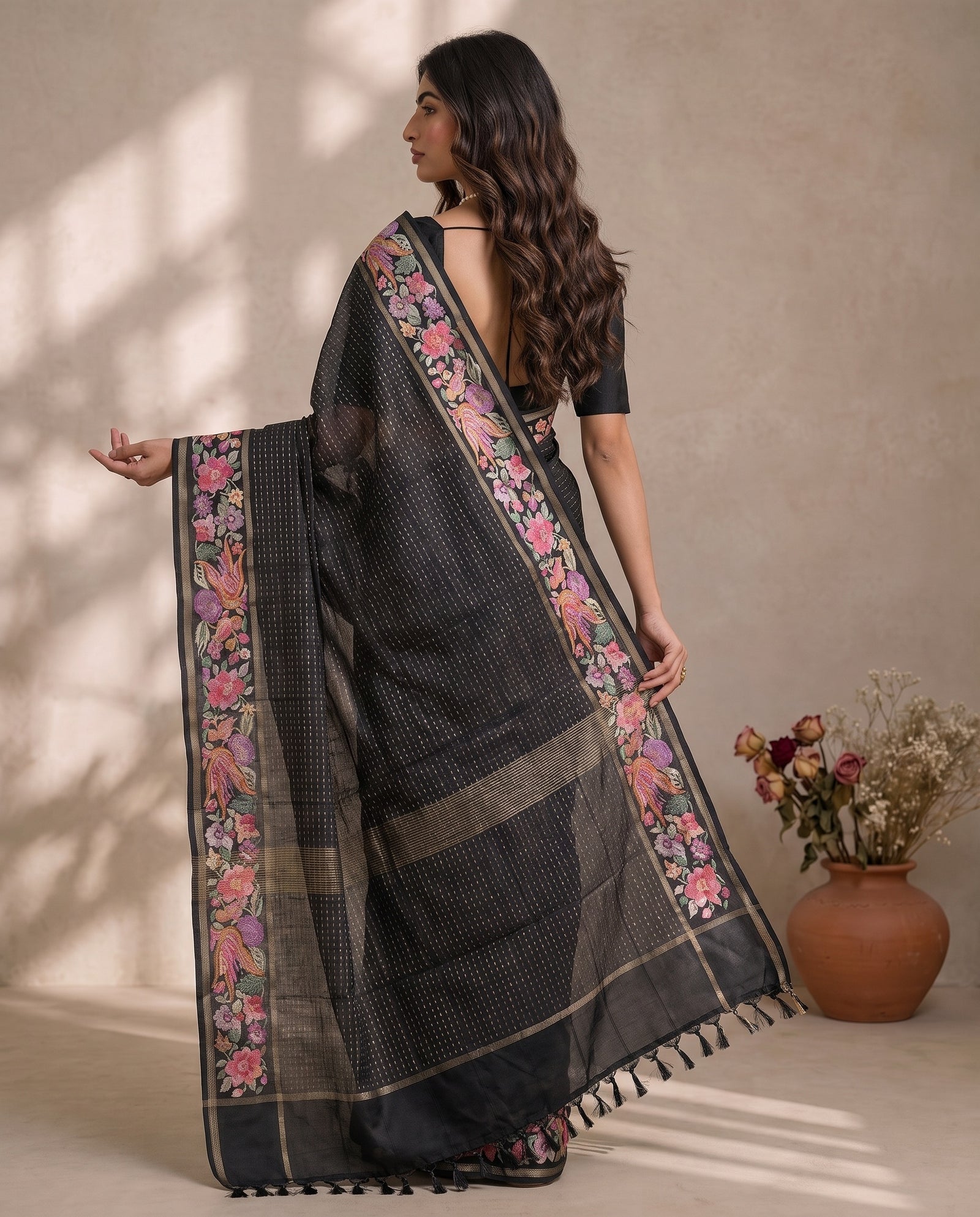 Back view of black pure tussar saree with woven zari lines