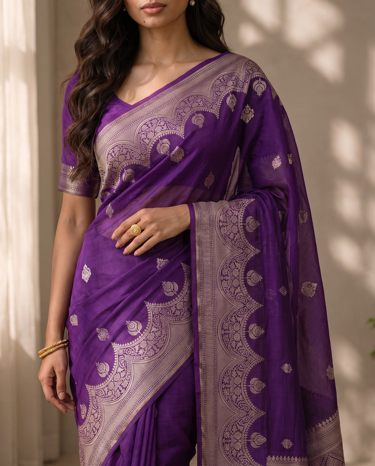 Mid-body crop showing purple fabric and woven butta motifs