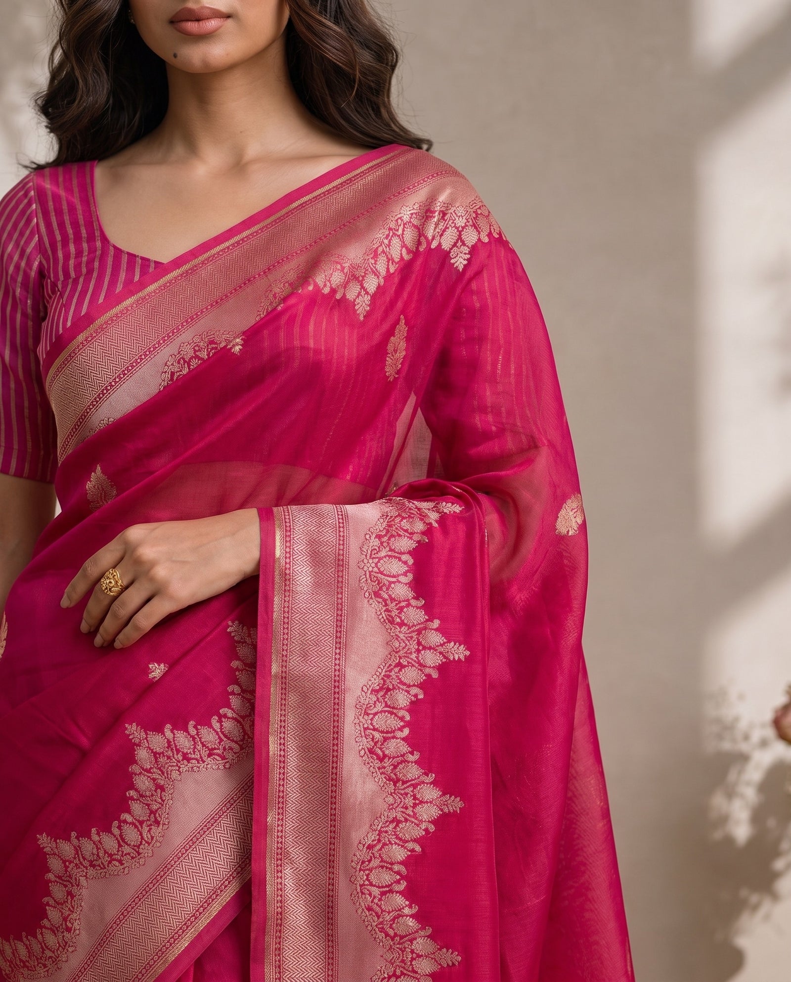 Mid-body crop showing woven zari butis on pink pure kora organza