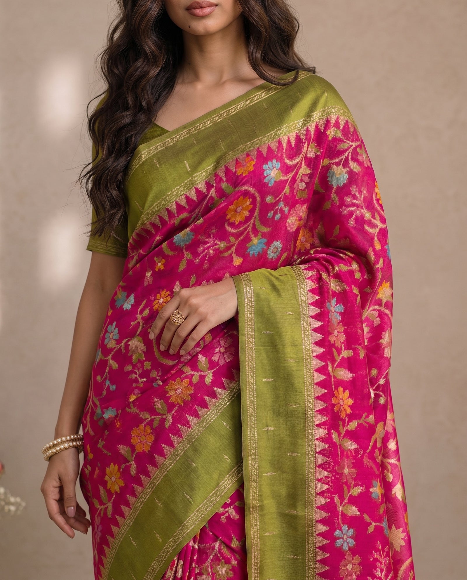 Mid-body crop showing the pink field woven with multicolour floral motifs