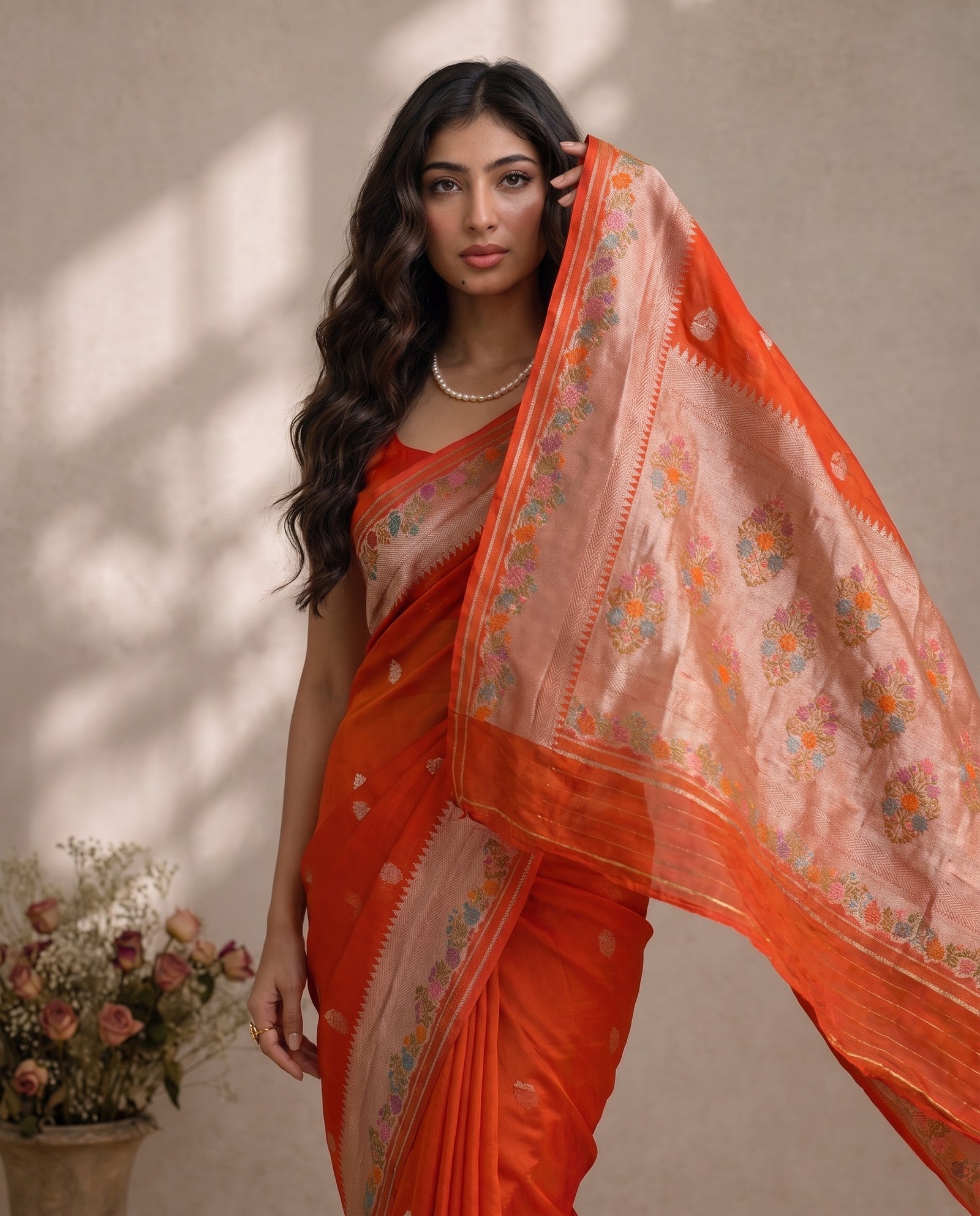 Mid-body crop showing woven motifs on orange kora fabric