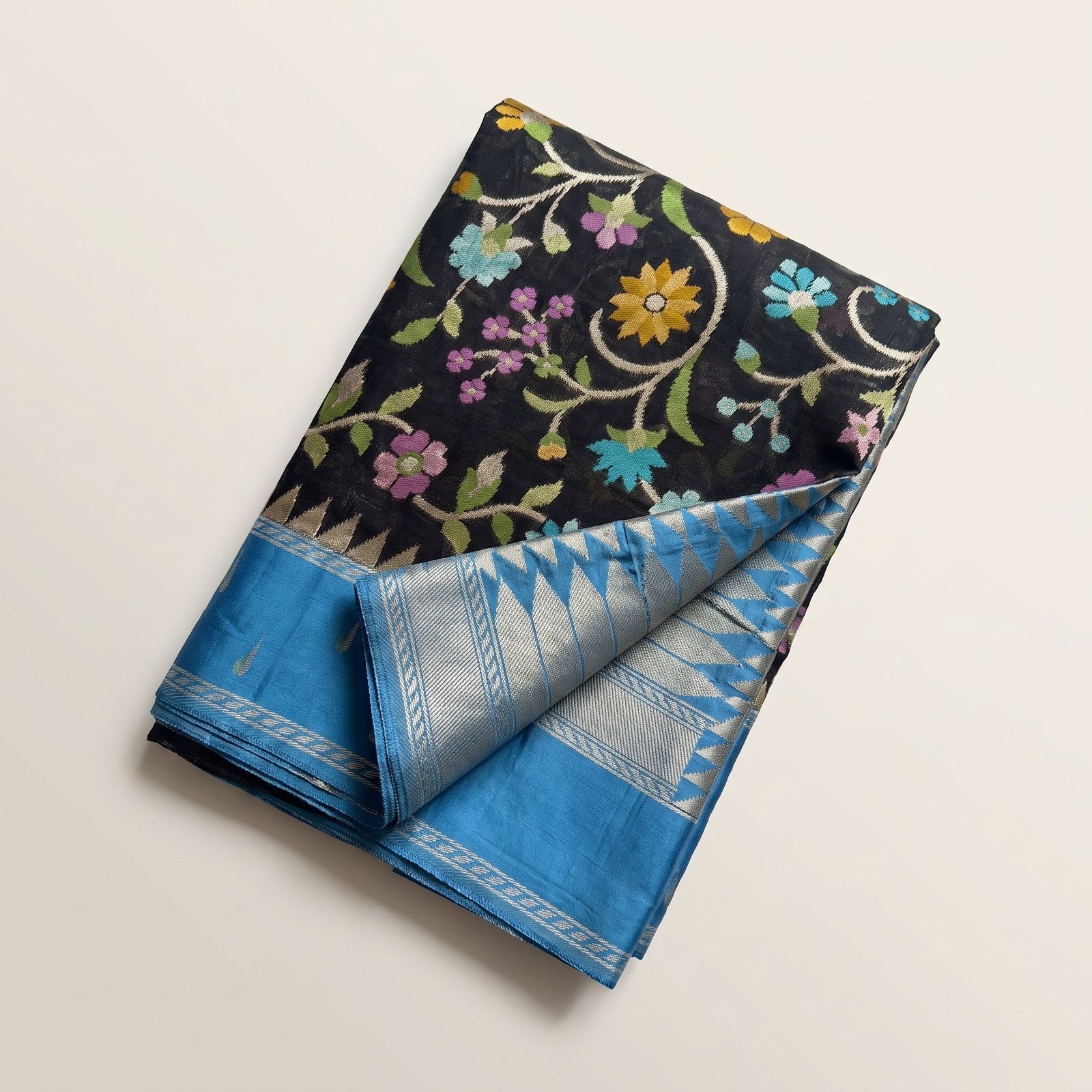 Mid-body crop showing multicolour floral weave on black kosa tussar