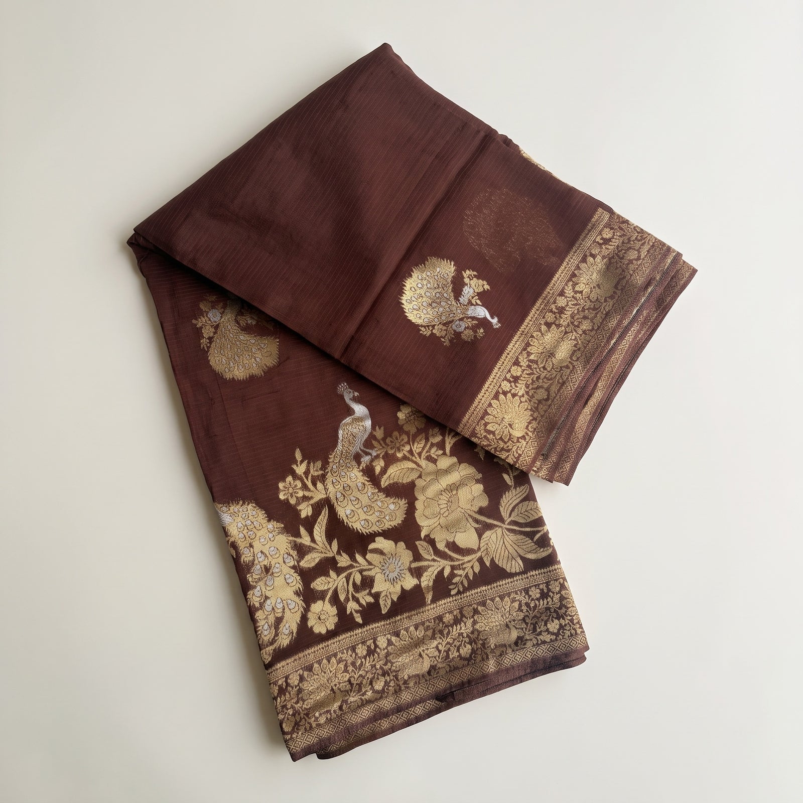 Mid-body crop showing woven peacock motifs across chocolate brown base