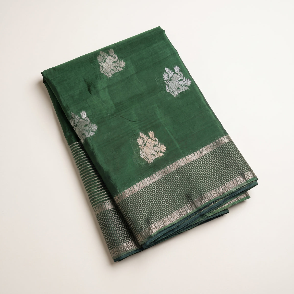 Mid-body view of green pure HO silk saree showing woven motifs