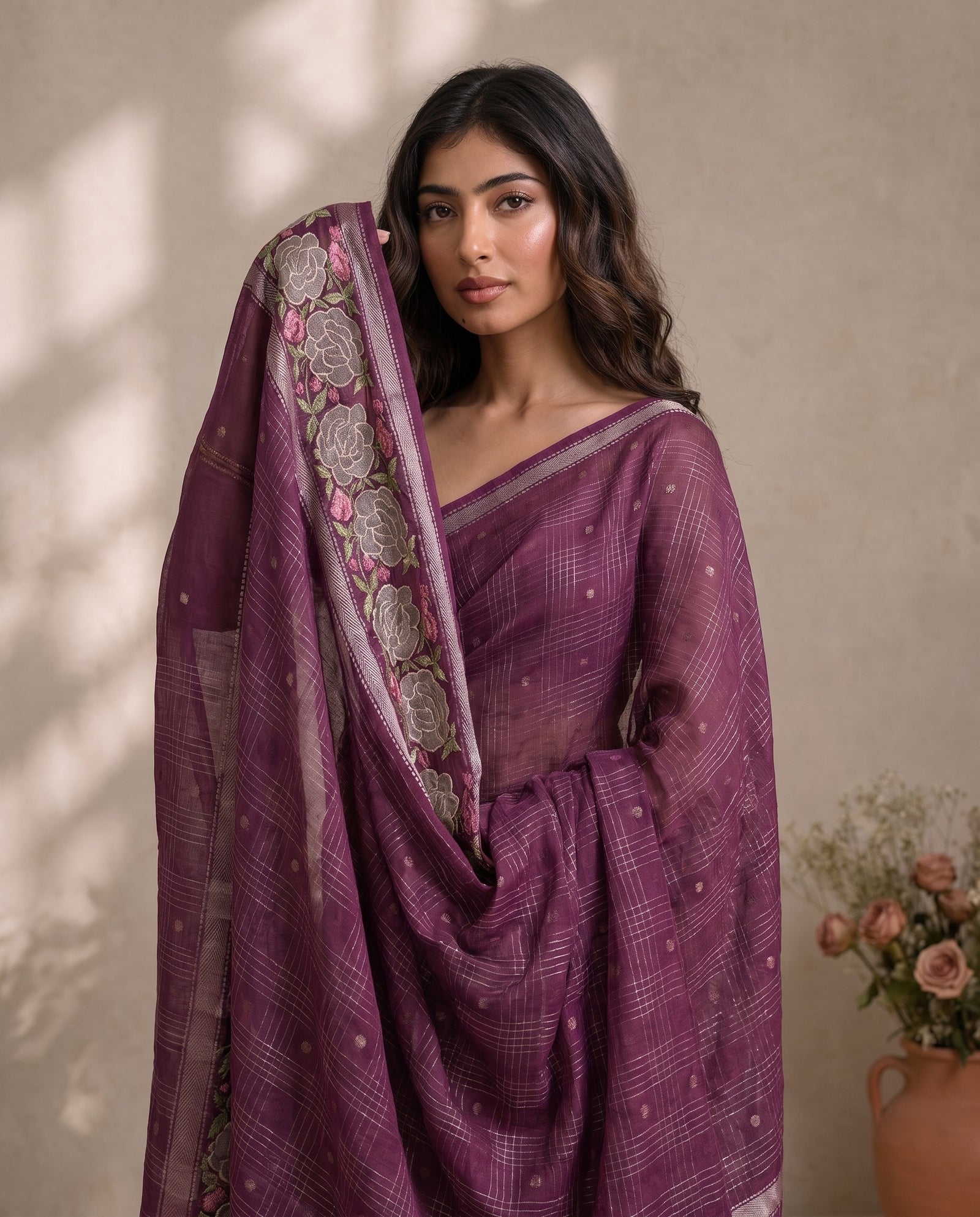Pallu draped over the shoulder displaying border detailing and tassels