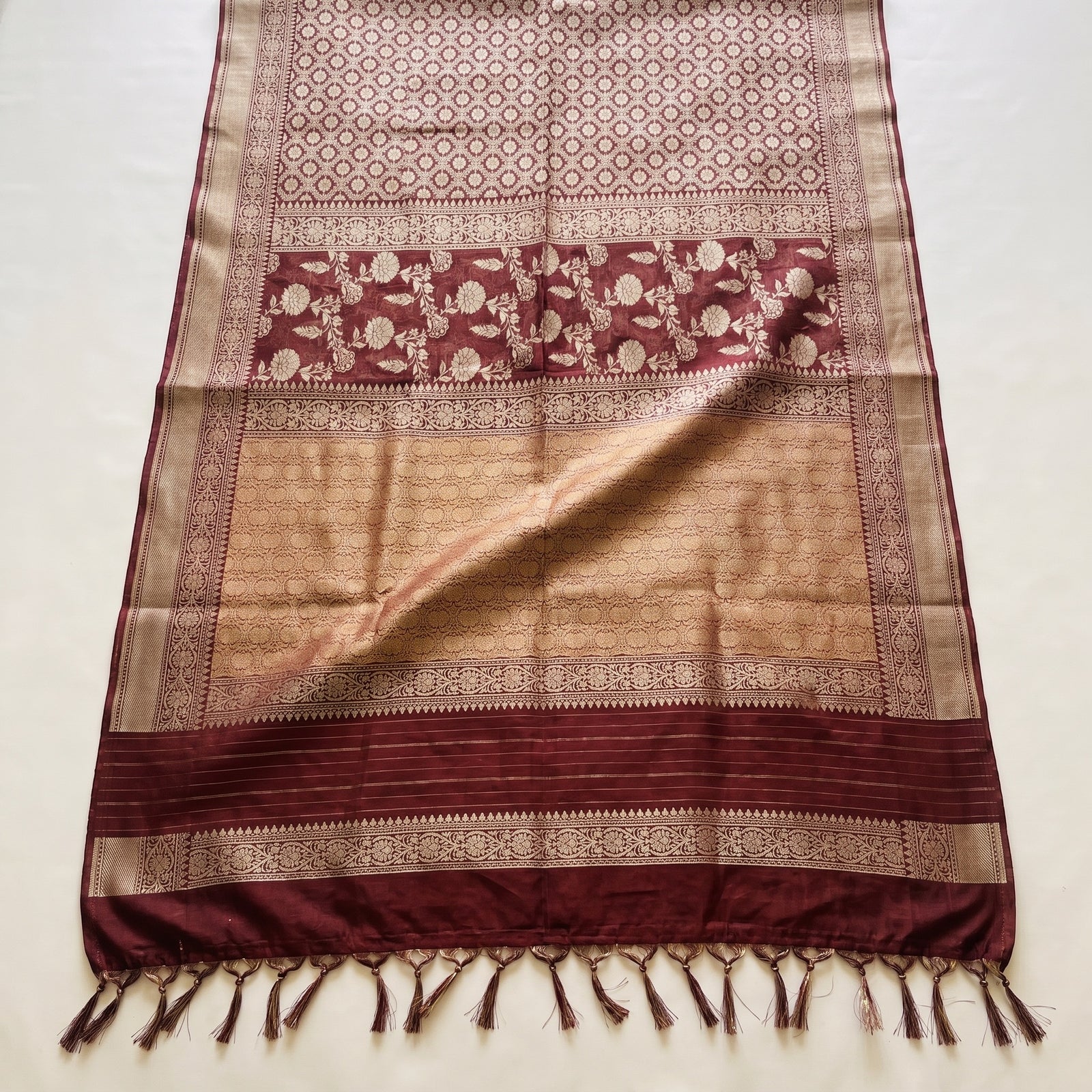 Pallu draped over shoulder of maroon pure kora Banaras saree