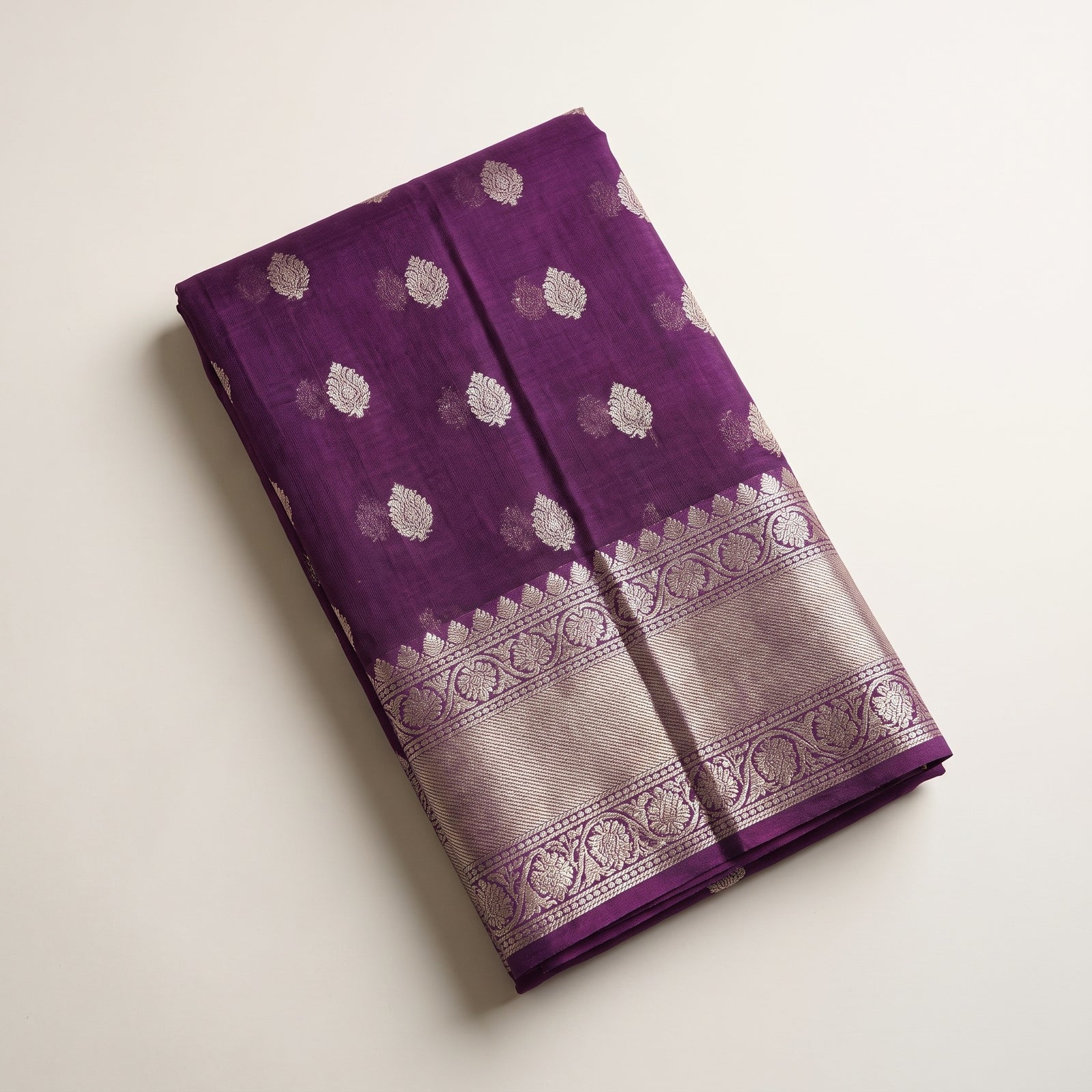 Folded view of purple pure Manipuri Kota saree showing border and motifs