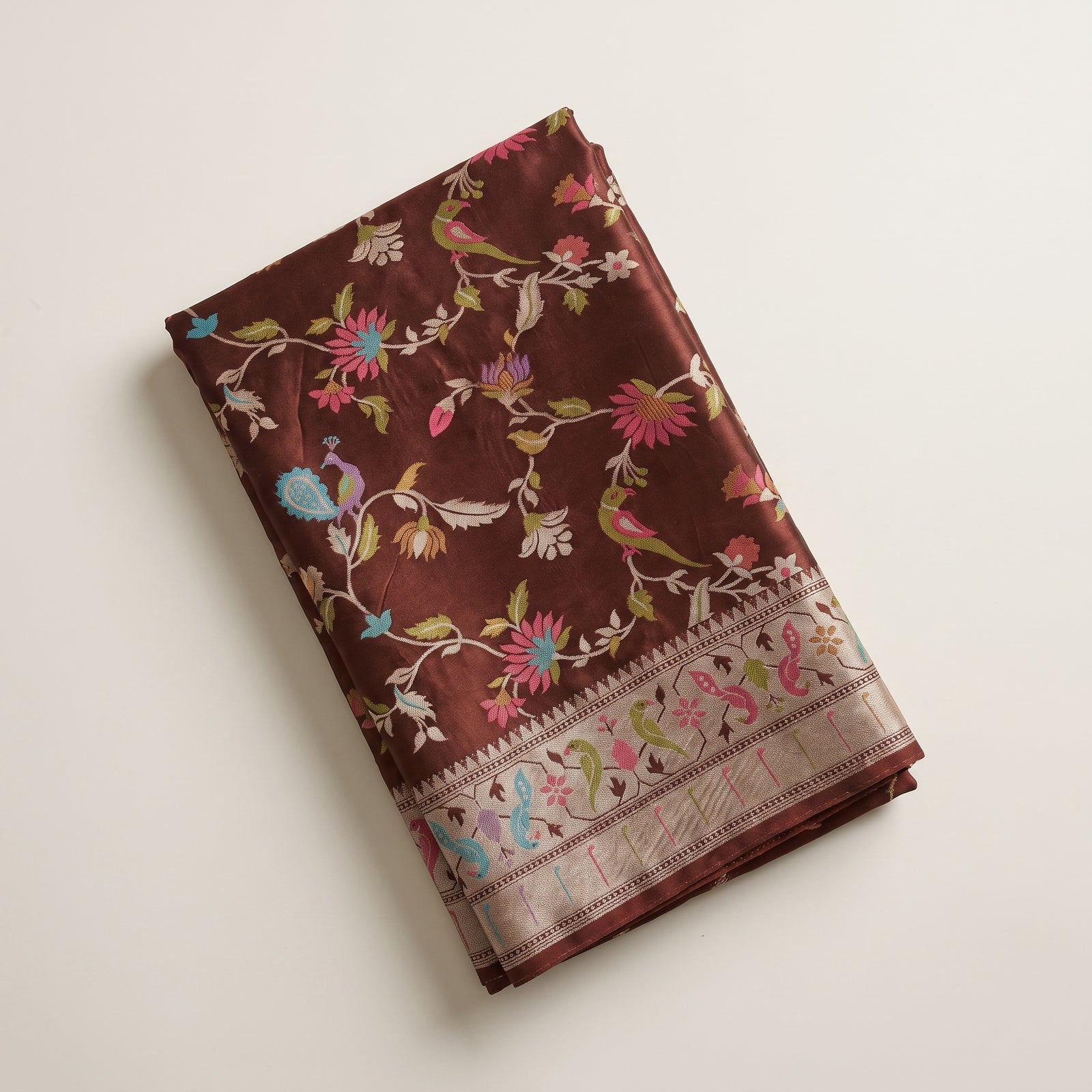 Folded hero shot of chocolate brown pure satin silk saree