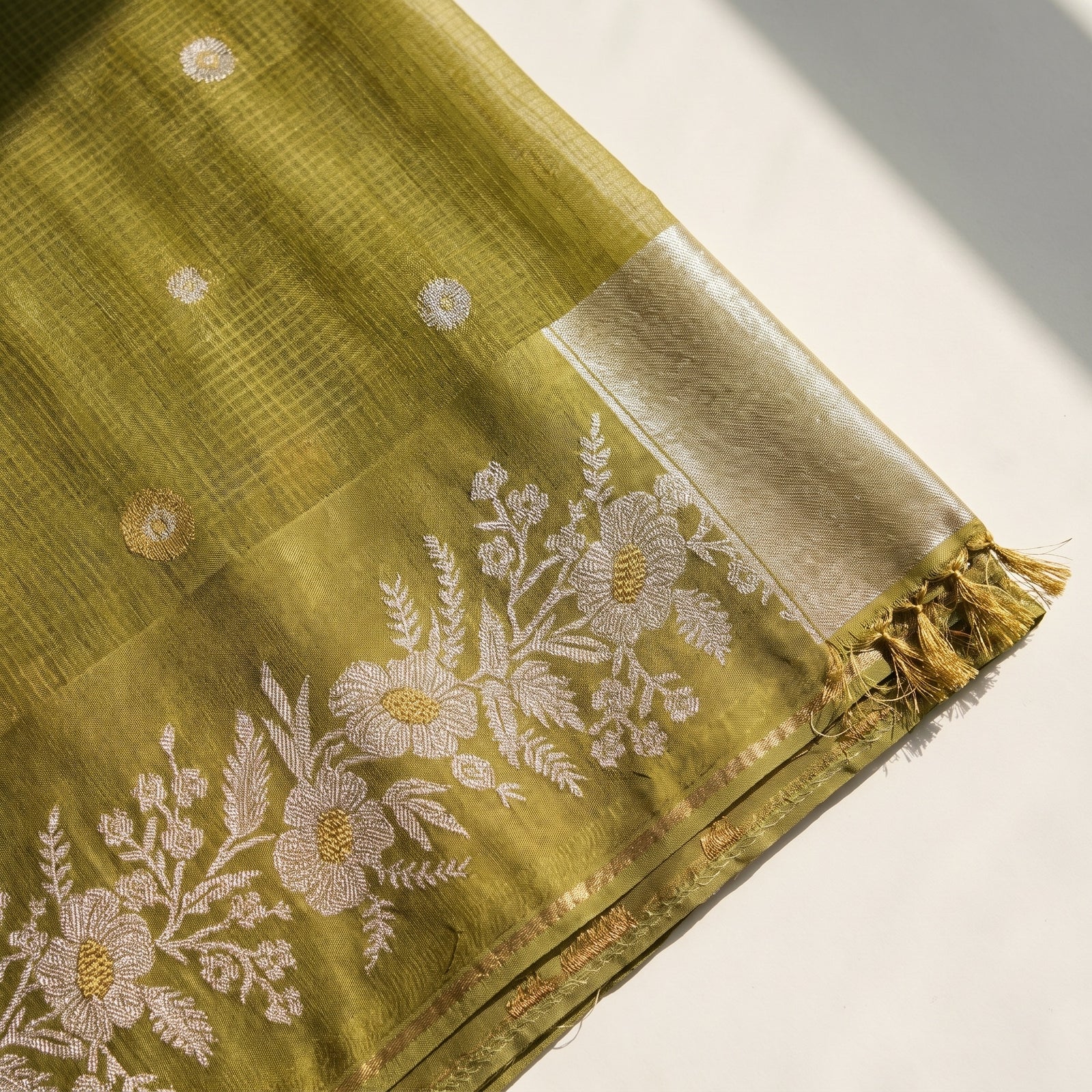 Folded olive green pure Manipuri Kota saree with zari border