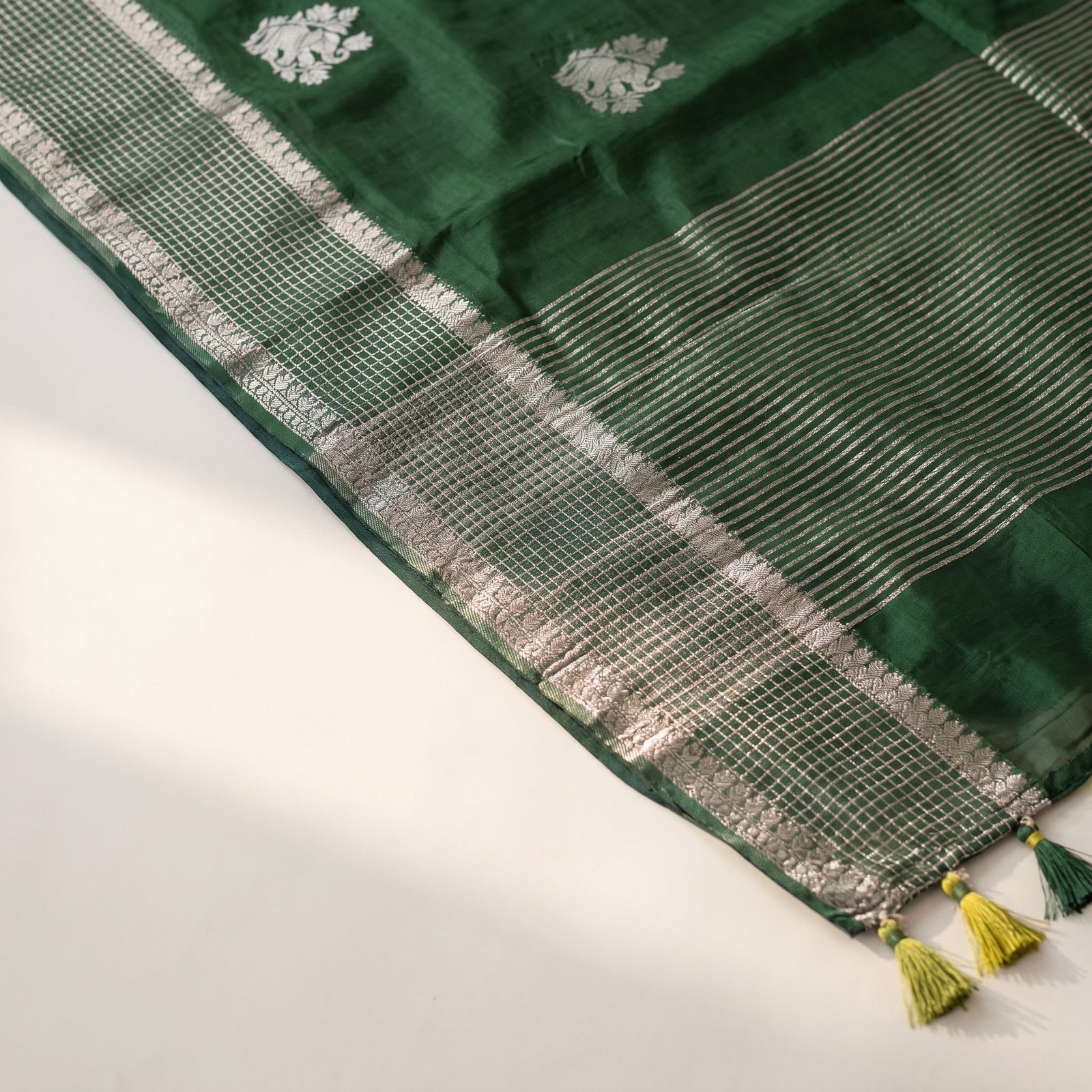 Neatly folded green pure HO silk saree with border detail
