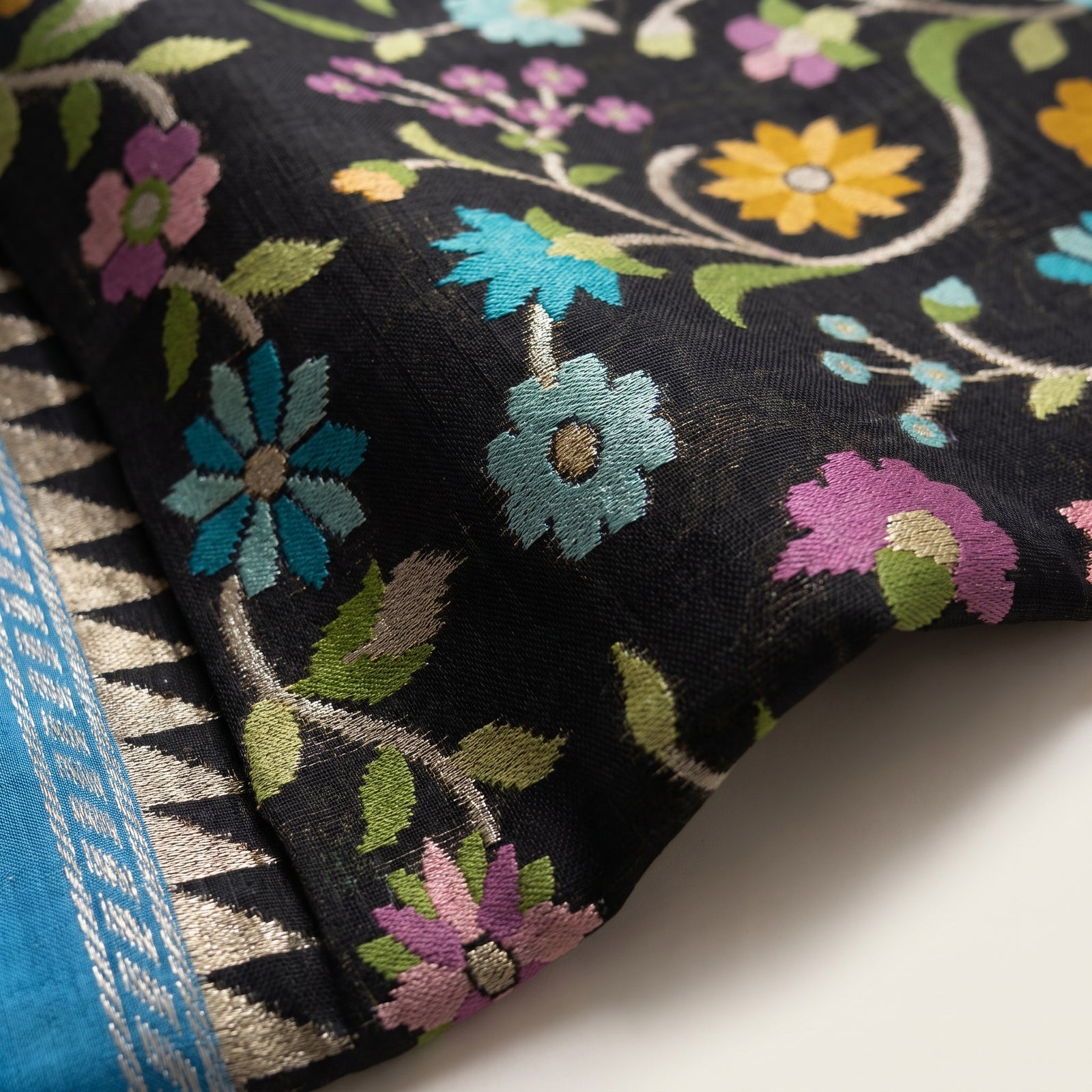 Folded hero view of black and blue pure kosa tussar saree