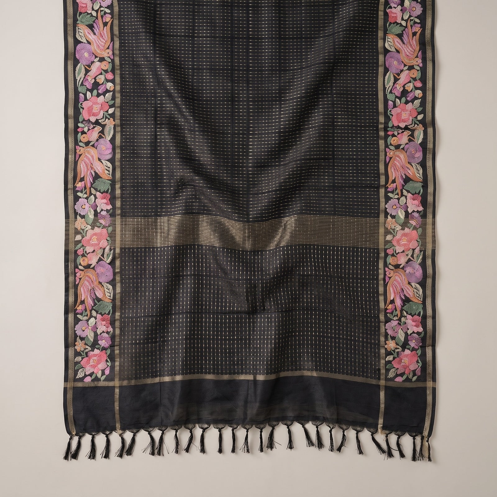 Flat spread of the black pure tussar saree body and pallu