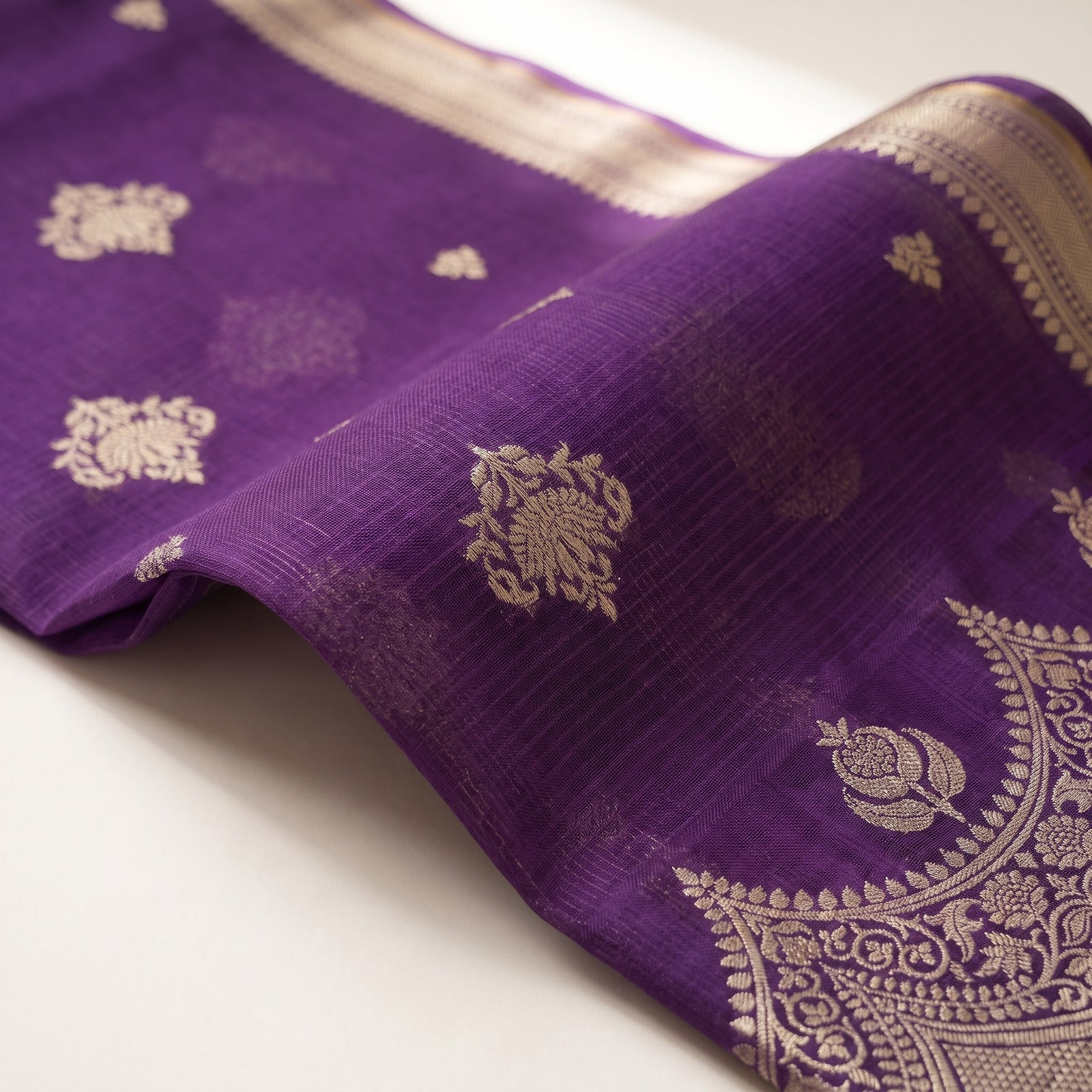 Flat spread of purple pure Manipuri Kota saree displaying the body and border