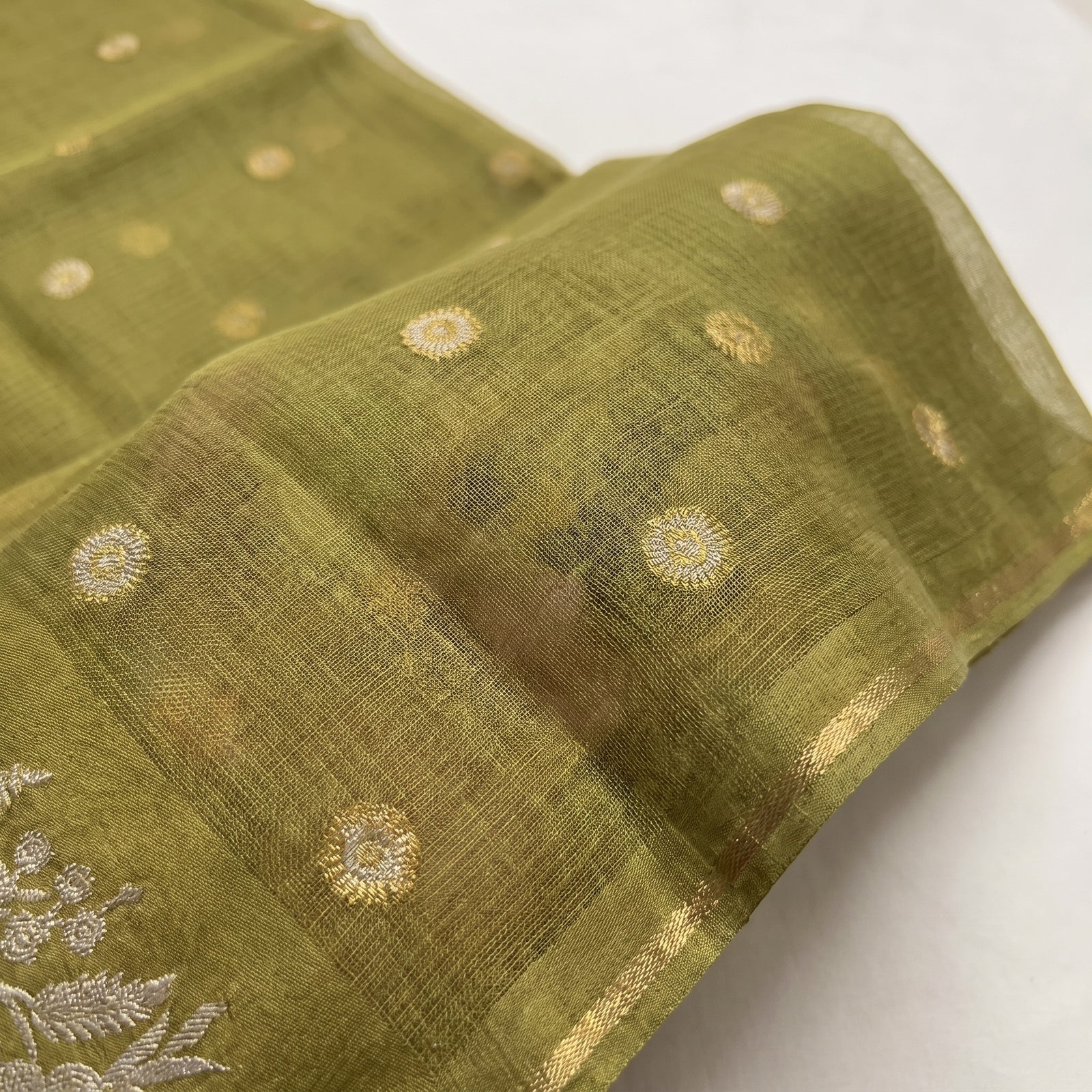 Flat spread view of olive green pure Manipuri Kota saree