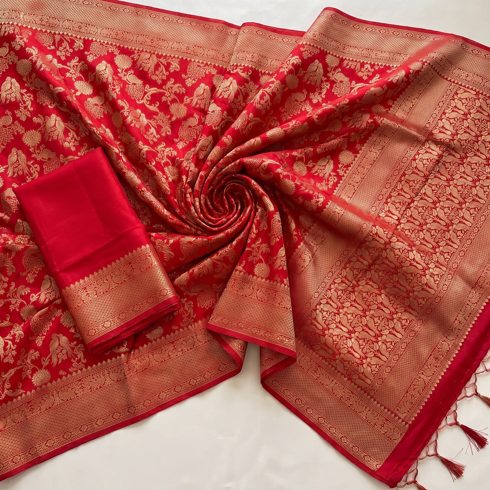 Close-up macro of the intricate woven border on Mirchi Red saree