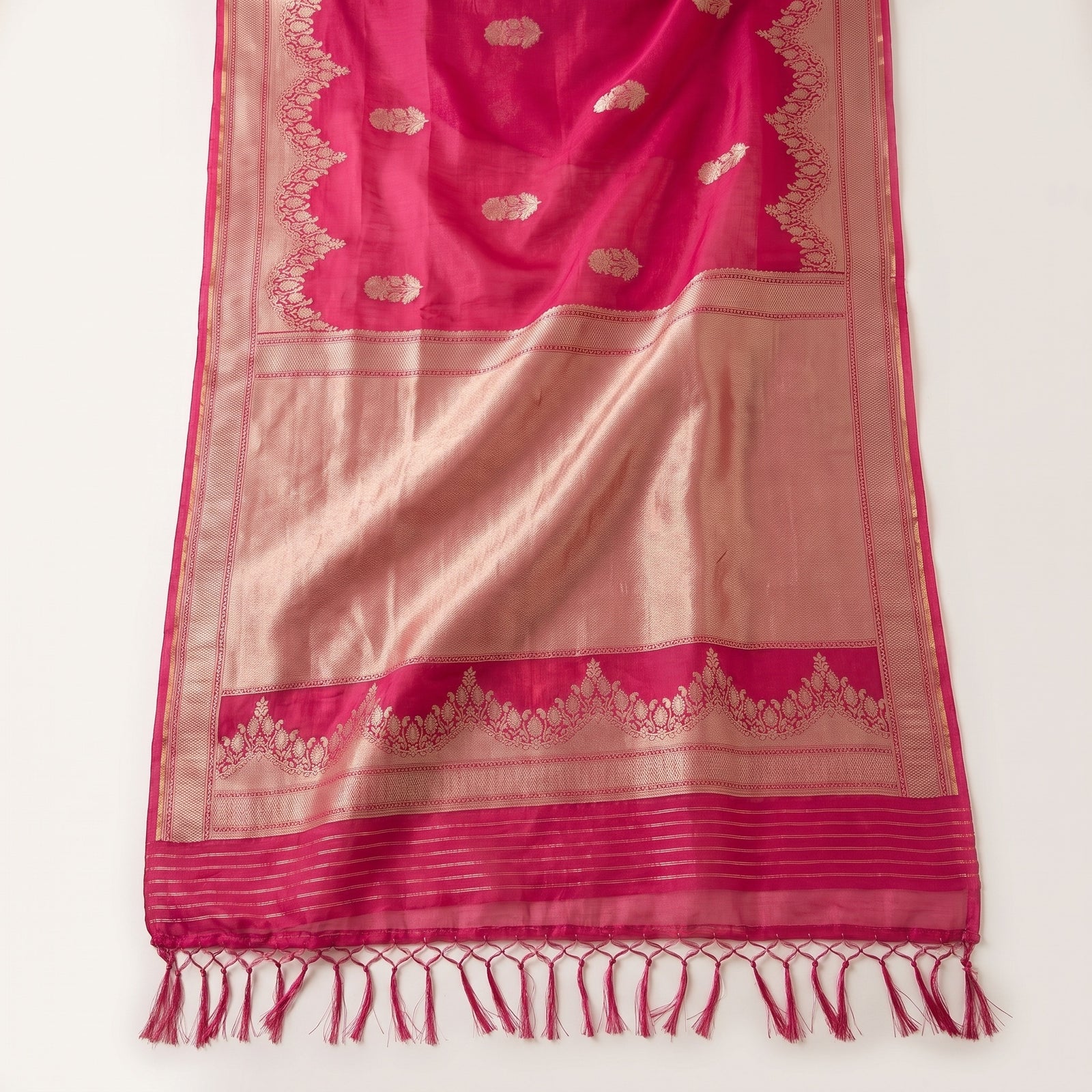 Detailed macro shot of woven zari border on pink organza