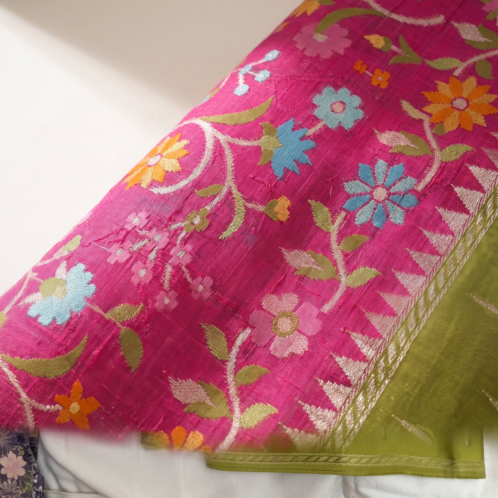 Spread view of the olive green pallu with fine woven linear bands